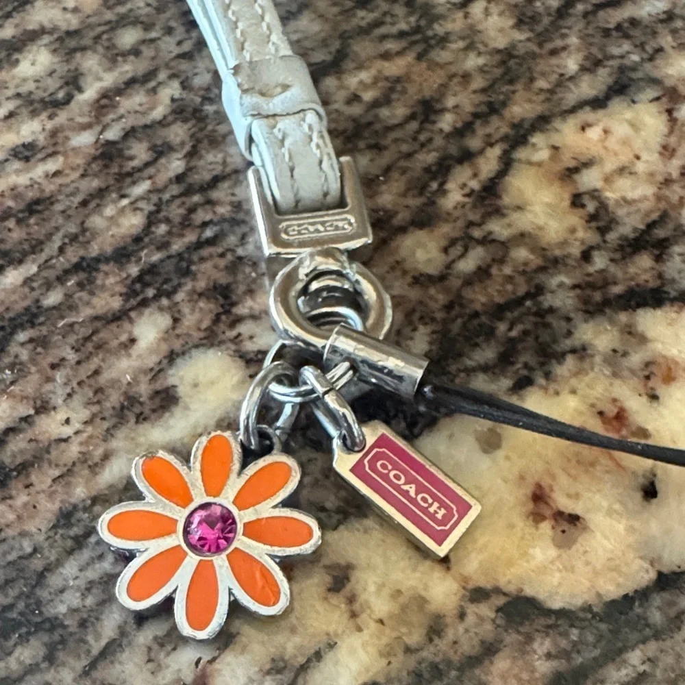 Coach White Wristlet with Orange Flower Phone Charm